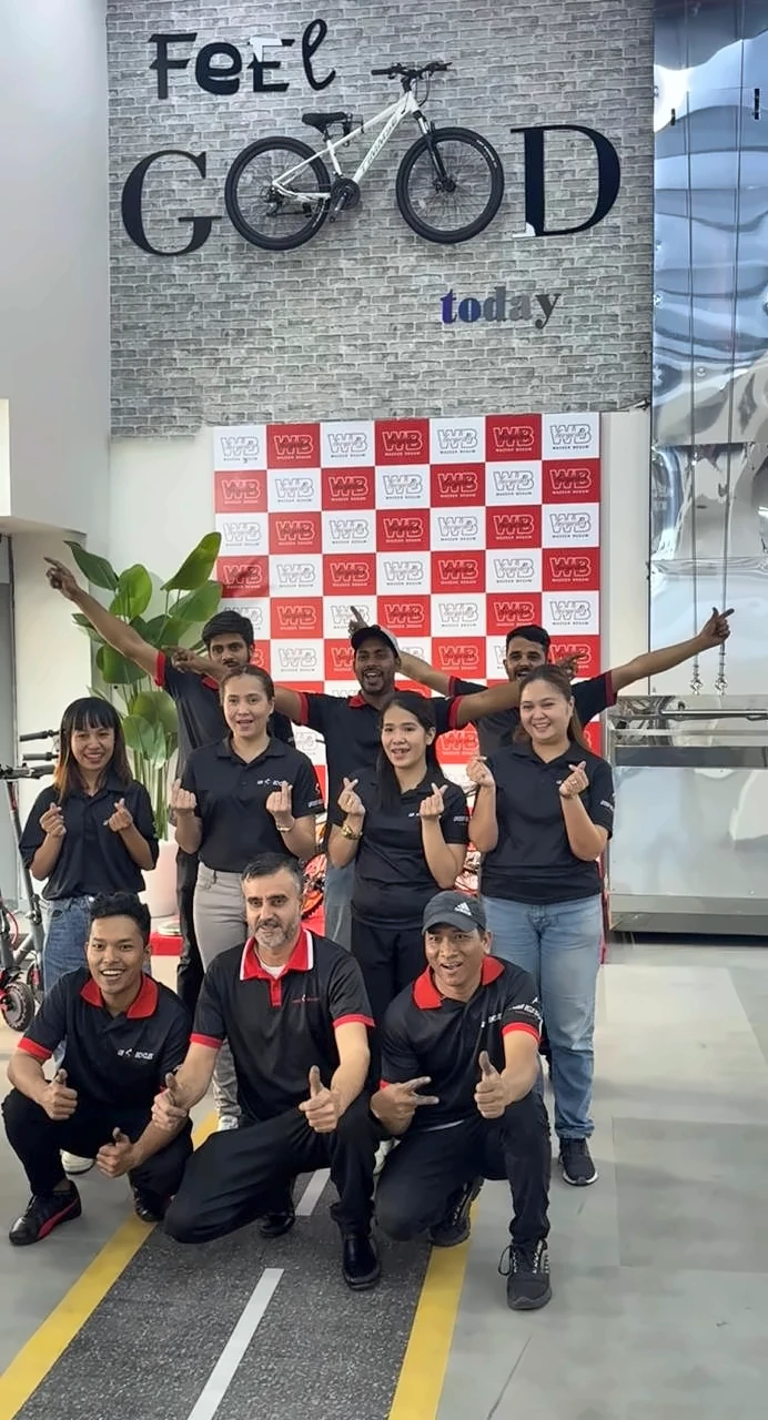 WB Bicycles team under the Feel GOOD today wall inside the Al Quoz Mall store